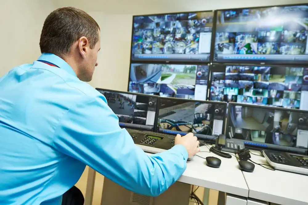 “Security monitoring room with officers reviewing surveillance footage to protect Marina Del Rey properties.”
