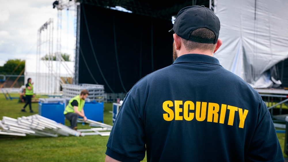 Rear,view,of,security,team,at,outdoor,stage,for,music